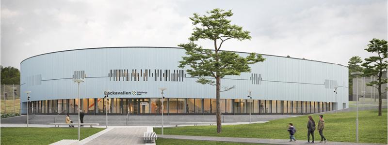 Backavallens sporthall byggs i trä med stående träpanel och stora glaspartier. Visionsbild: D-office